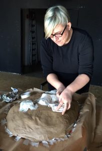 Zoe Gudovic works on her mask at the Macanudos Workshop 